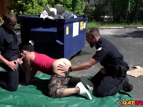 Two police officers engage in hot gay interracial action in the parking lot.