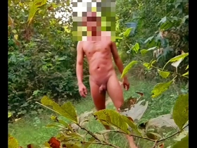 Gay Myanmar man goes for a naked walk in the woods with an anal plug.