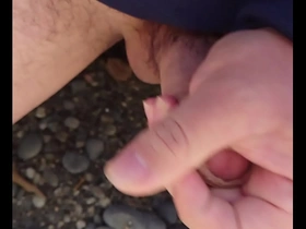 Gay Japanese man masturbates outdoors and ejaculates.
