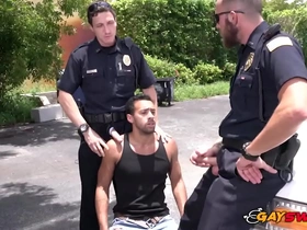 Two hot gay police officers are robbed and orally sexed by a street thug in an alleyway.