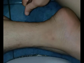 A solo boy gives a massage to himself at home.