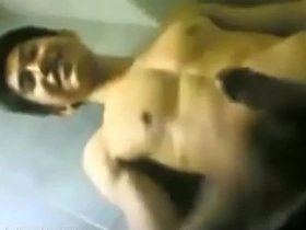 Asian guy smiles while he pleases himself.