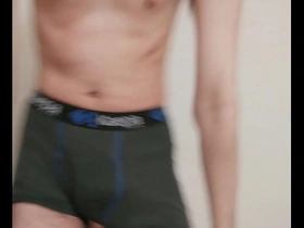 A young gay man strips naked.